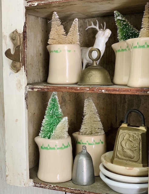 creamers with trees inside of them