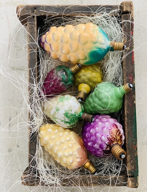 a box full of figural bulbs in the shape of fruit
