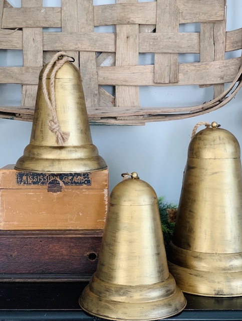 Golden Christmas Bells sitting on a shelf