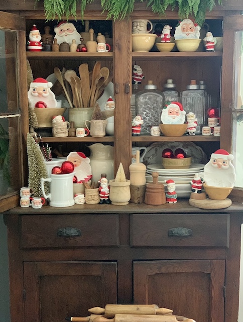 vintage santas in a kitchen cabinet