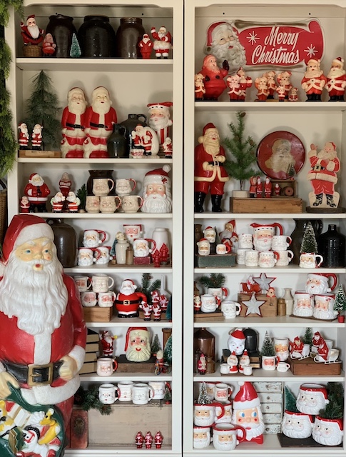 a shot of two of the shelvves full of vintage santas