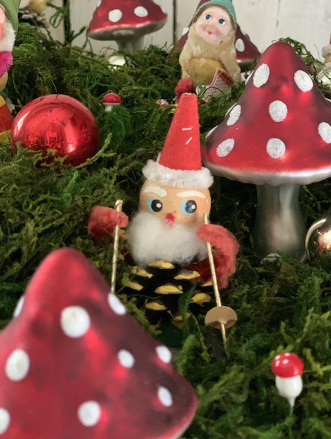 close up of the little vintage pinecone elf with a red hat
