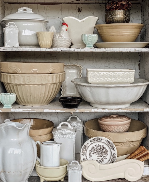 shelves filled with collectible pottery
