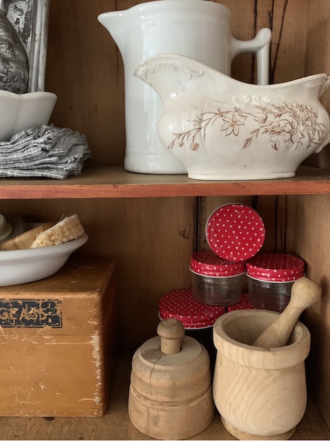 shelves with creamers and heart jars