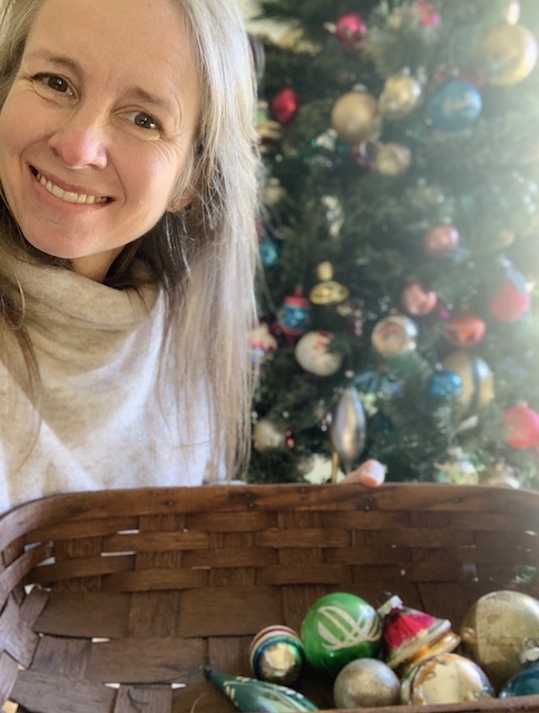 Me holding a small basket full of ornaments