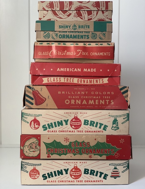 a stack of vintage christmas ornamnet boxes