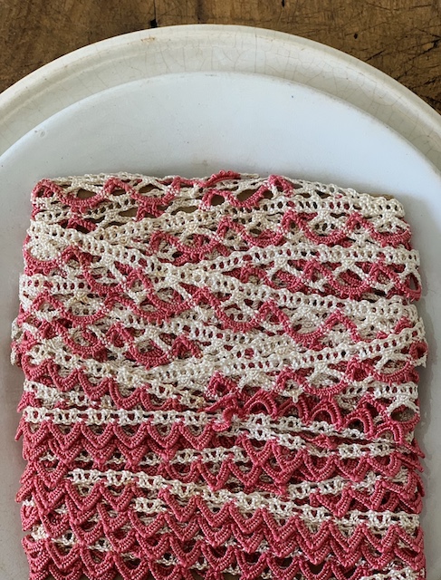 a roll of vintage pink and white lace