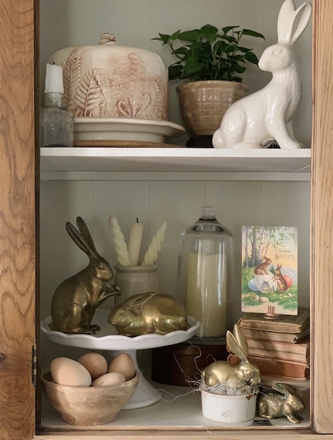 a very bunny display using ceramic and brass bunnies