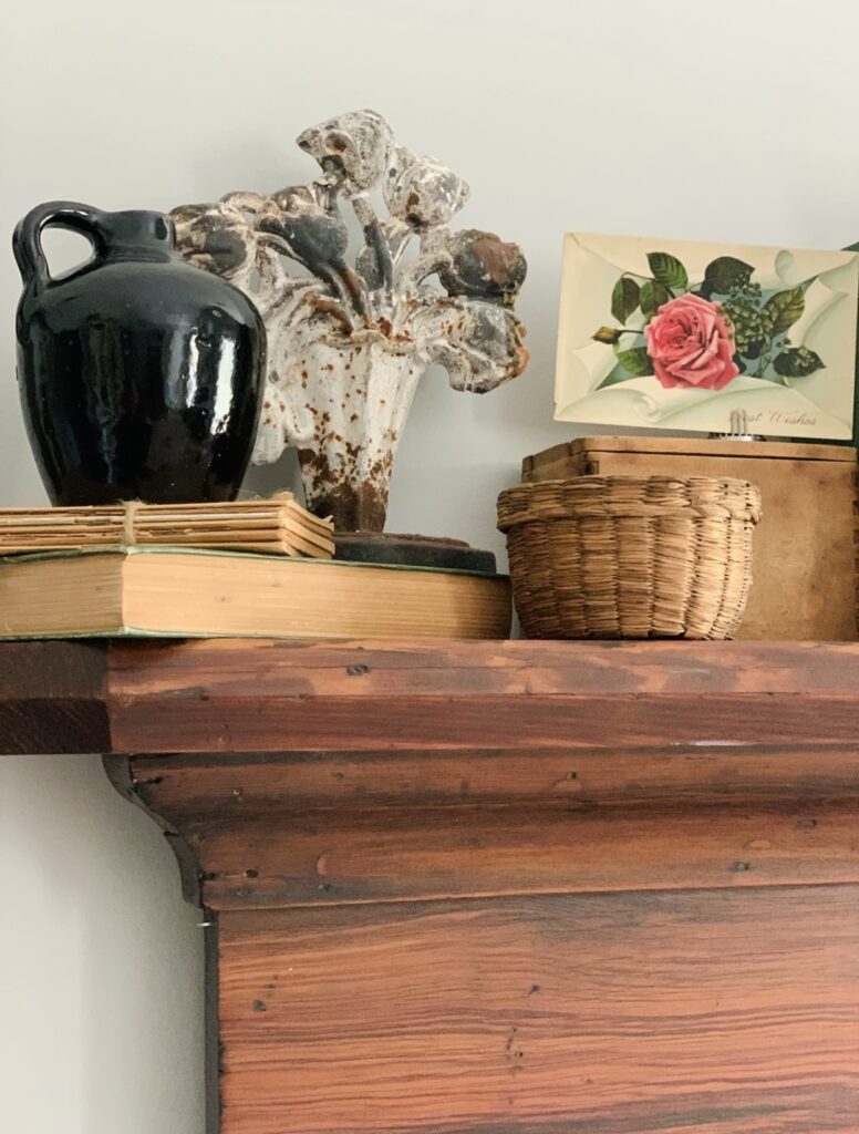 the side of the vintage spring mantel with a few finds on it