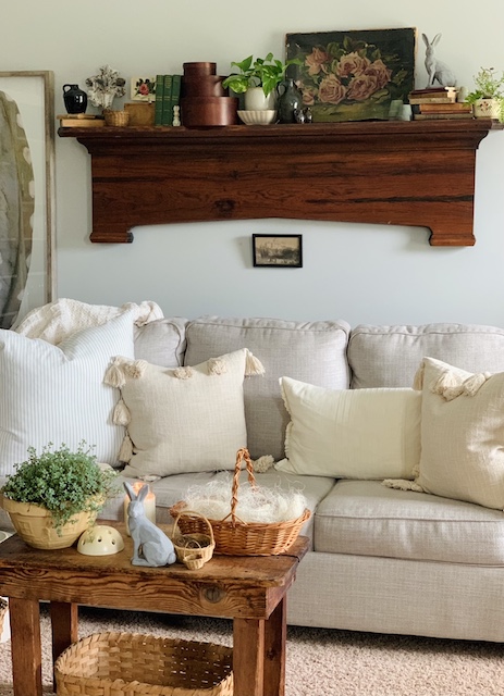 a side view of the couch with the vintage spring mantel 