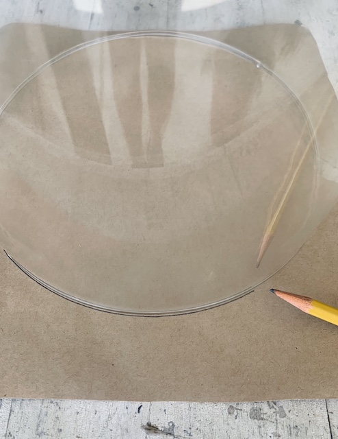 using a pencil to trace the base of the glass