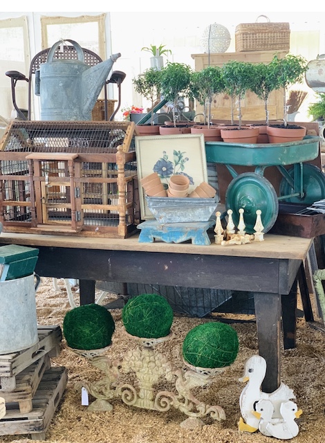 a cure little vintage garden display in a space full of antique and vintage finds