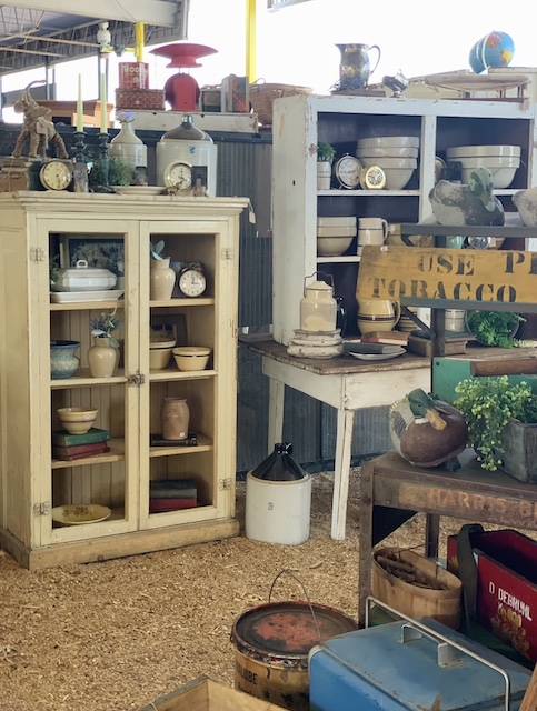 shelves full of antique and vintage finds in a new booth