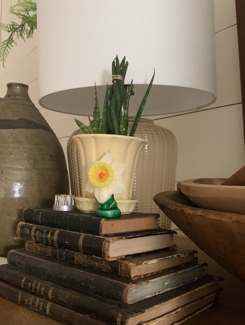 one of the gurley flower candles sitting on a stack of books