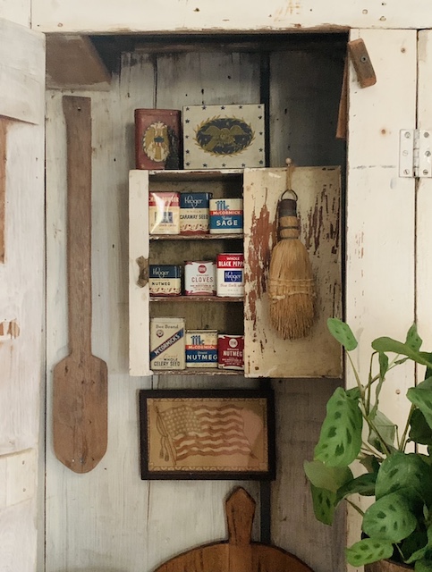 a view of the old spice tin inside this vintage patriotic kitchen cupboard