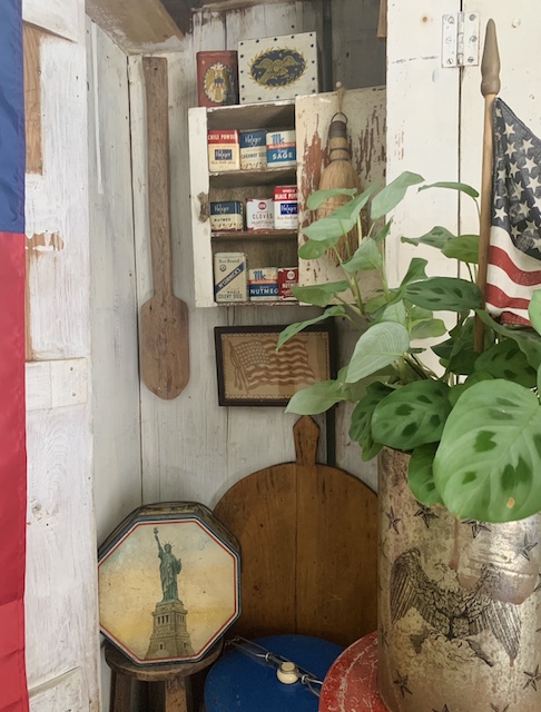 a view of the vintage patriotic kitchen cupboard from the side