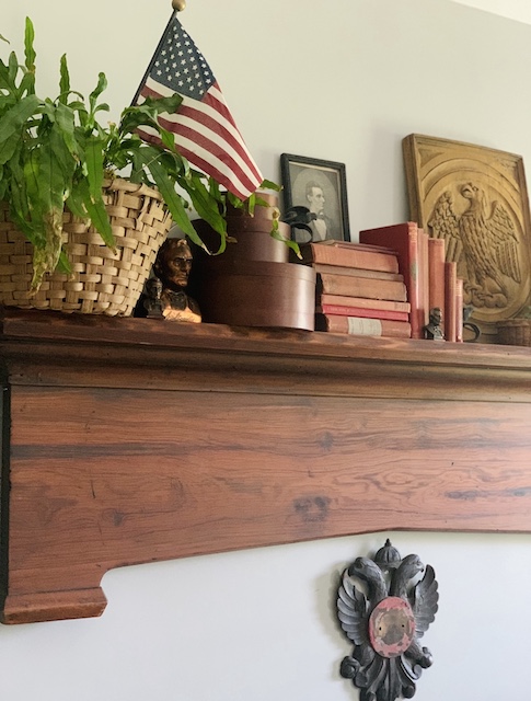 lots of patriotic items on a wall mantel