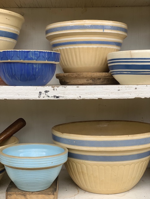two shelves of blue bowls