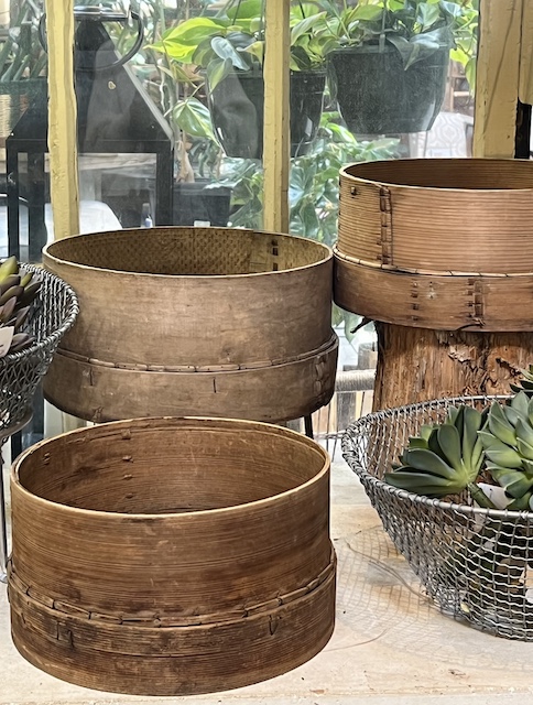 old grain sifter boxes used in a display