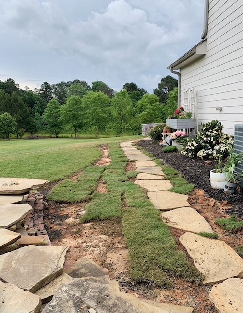 adding the sod around the cottage style stone path - 