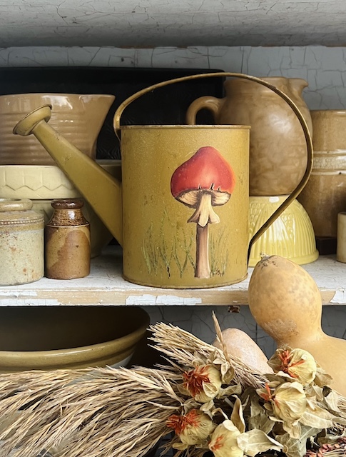 close up of watering can in my vintage fall shelf styling