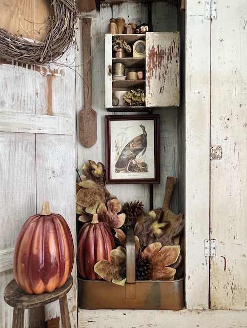 A simple Fall Cabinet styled with leaves and other items for fall
